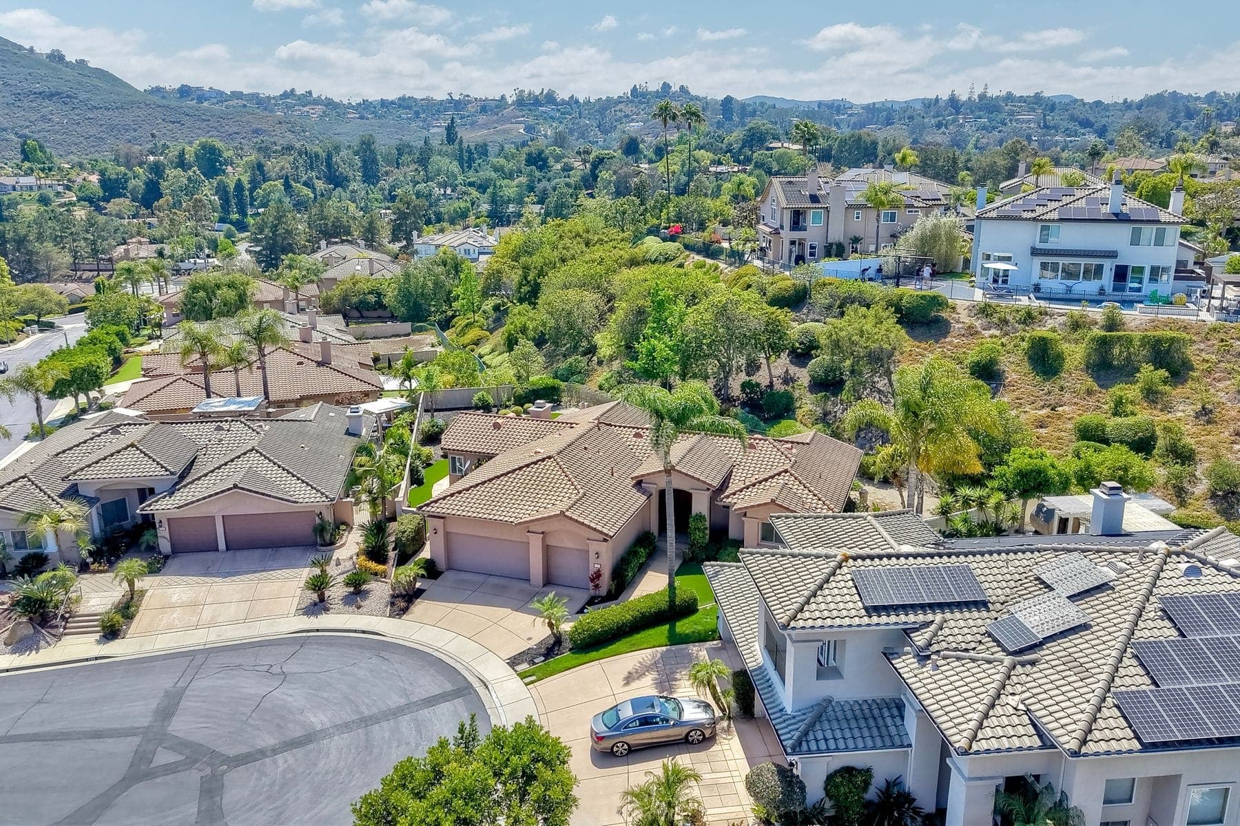 Aerial view of a hillside neighborhood of tile-roofed homes